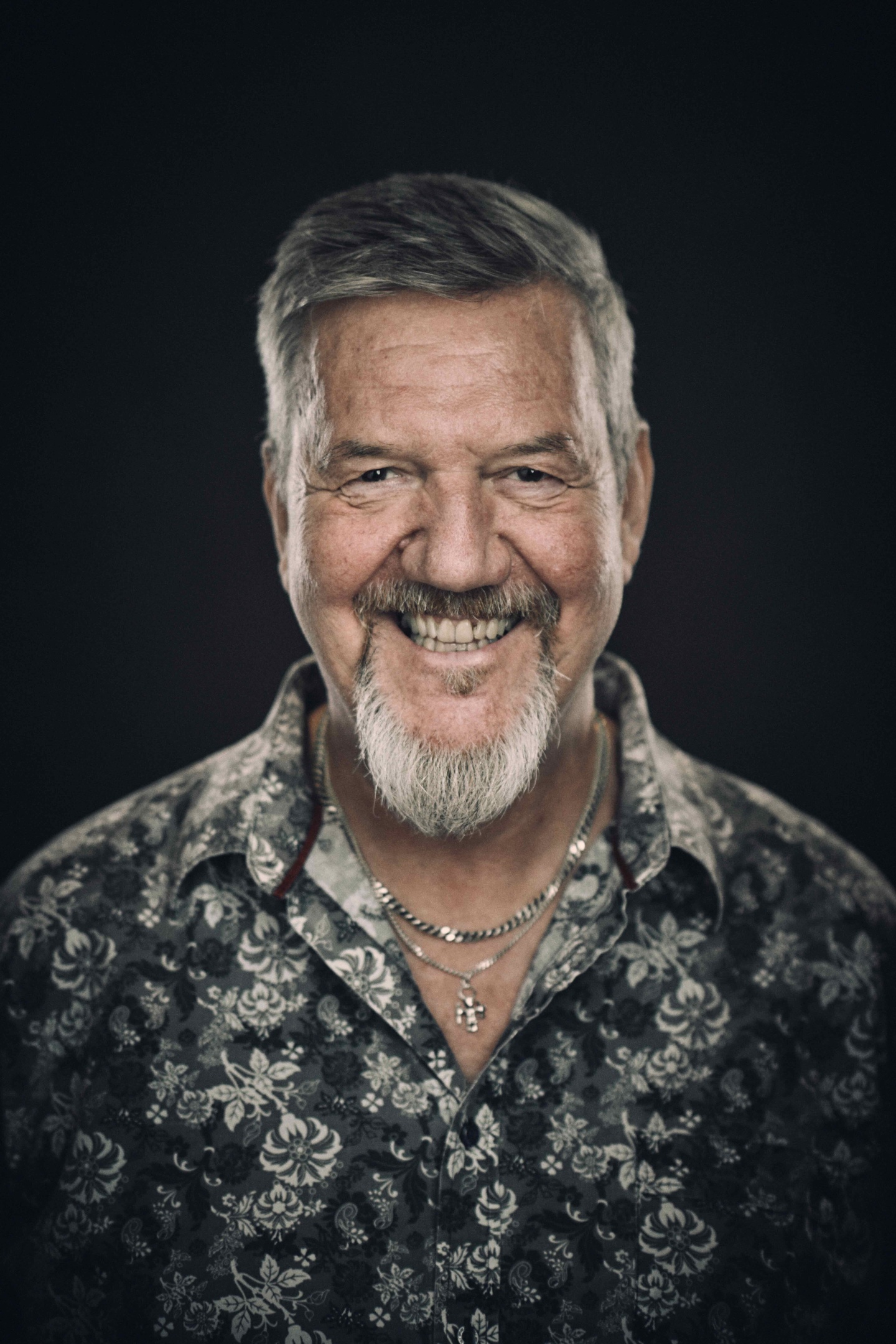 a man with long hair playing a guitar
